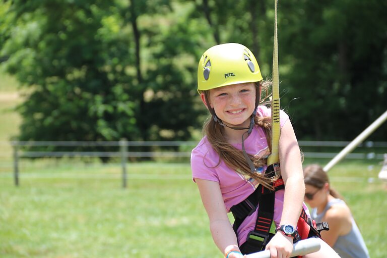 Camper smiling on zipline