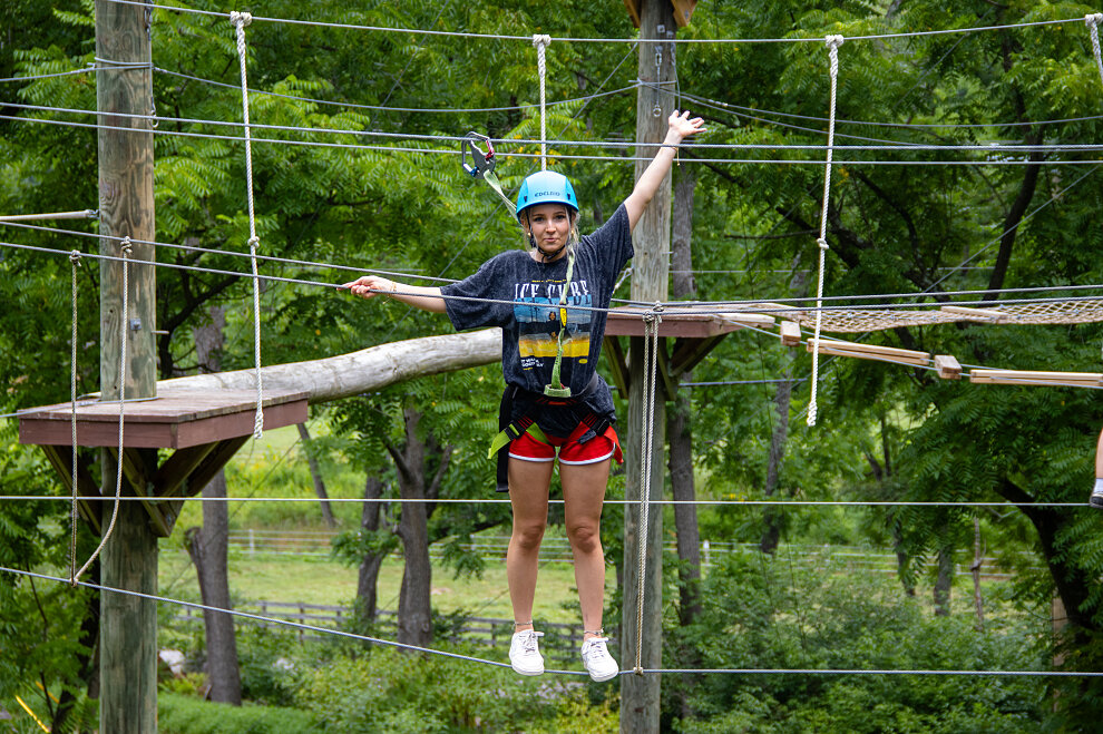 Camper smiling on high ropes course